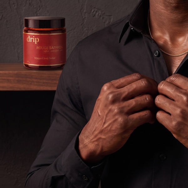 Buttoning his shirt, ready to walk out